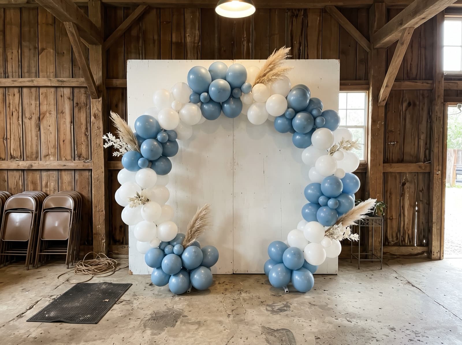 Round balloon arch in dusty blue and white with dried pampas