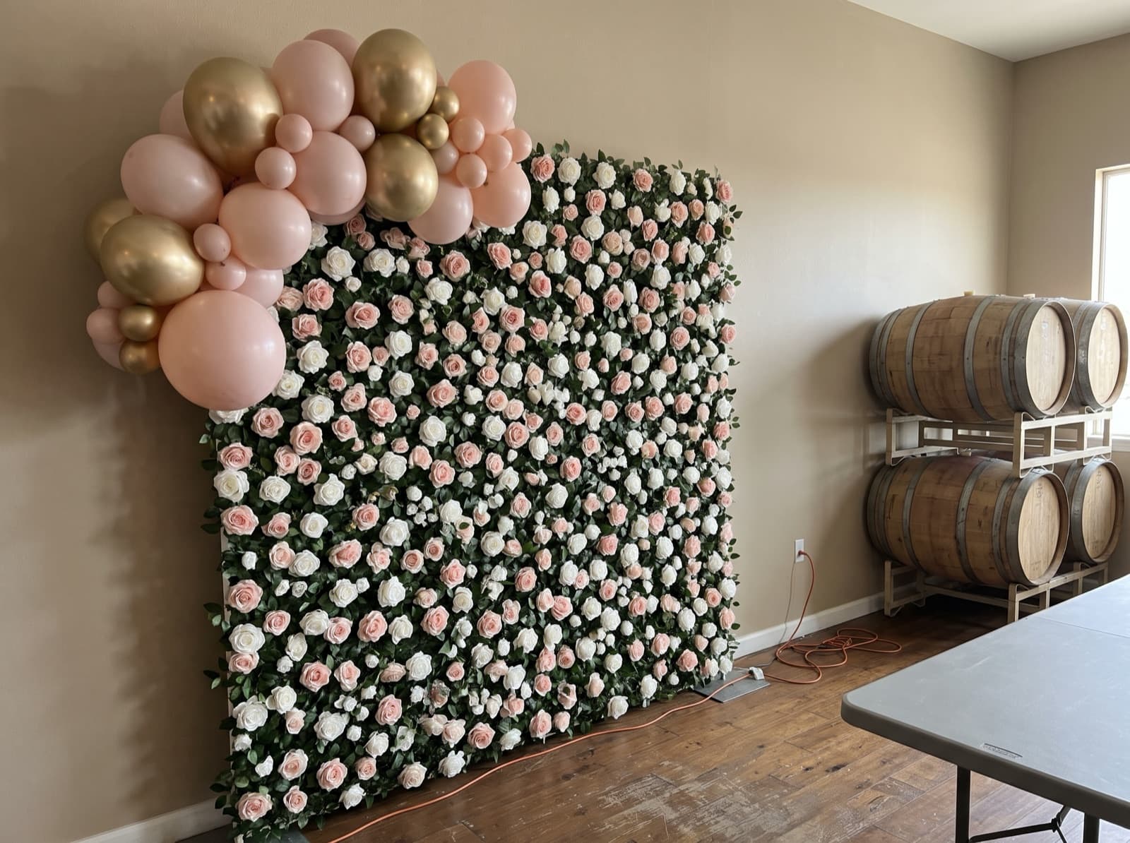 Flower wall backdrop with a blush and gold balloon garland