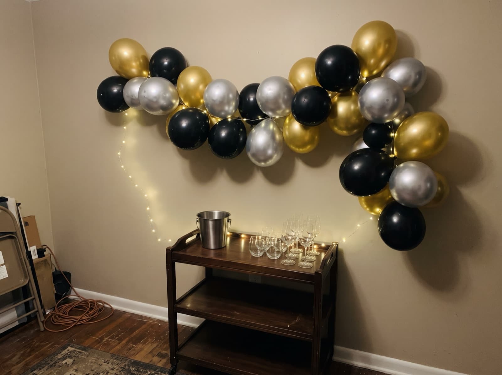Chrome balloon garland over a home bar for New Year's Eve