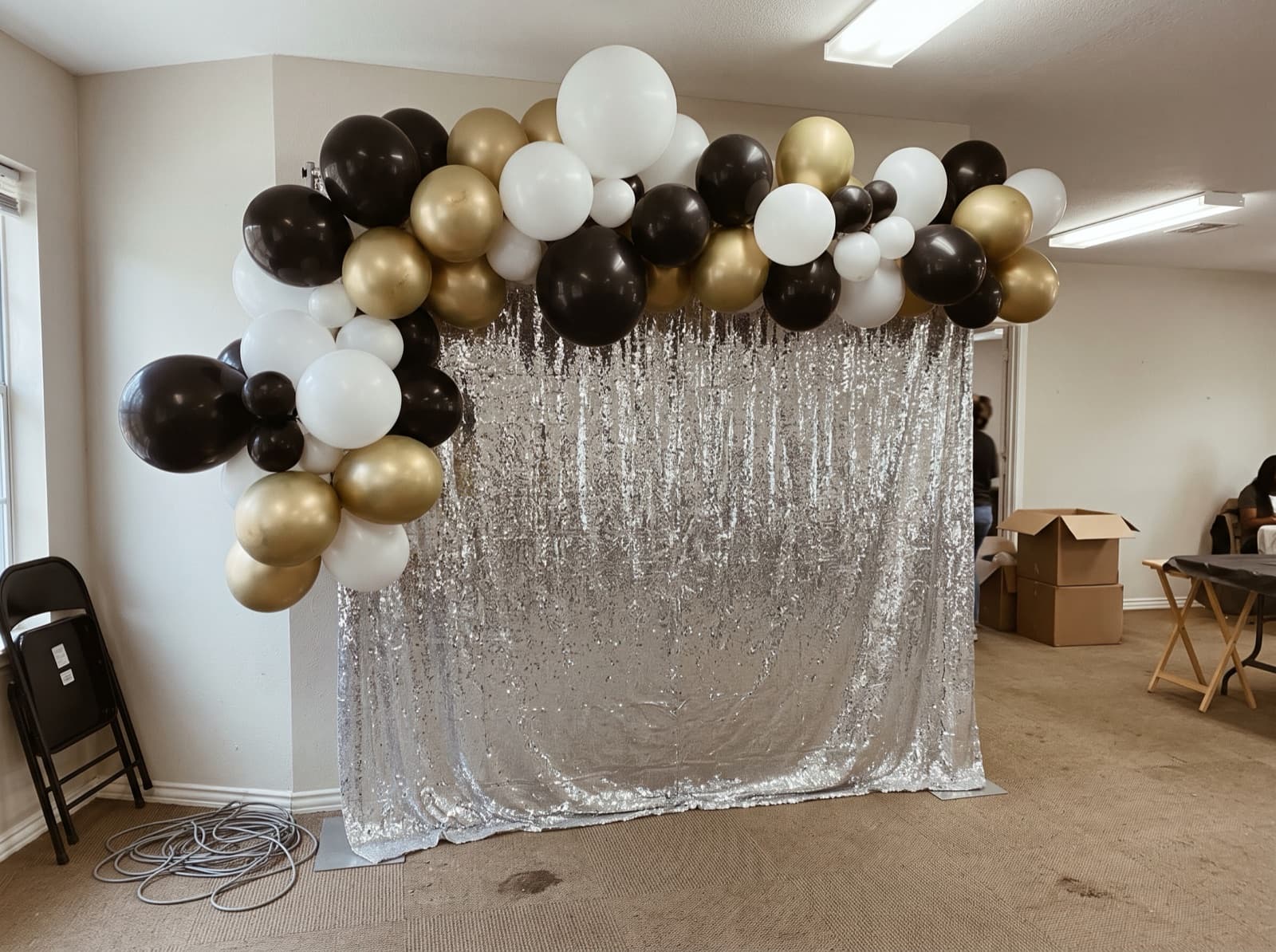 Balloon garland over a silver shimmer wall