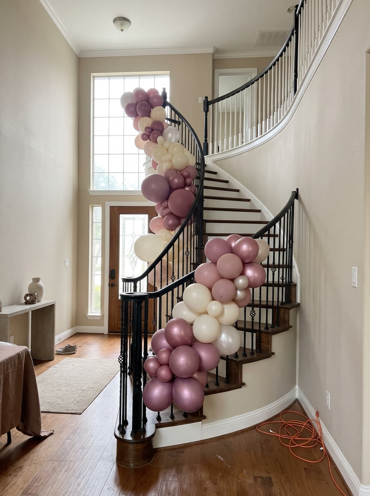 Balloon garland winding down an iron staircase railing