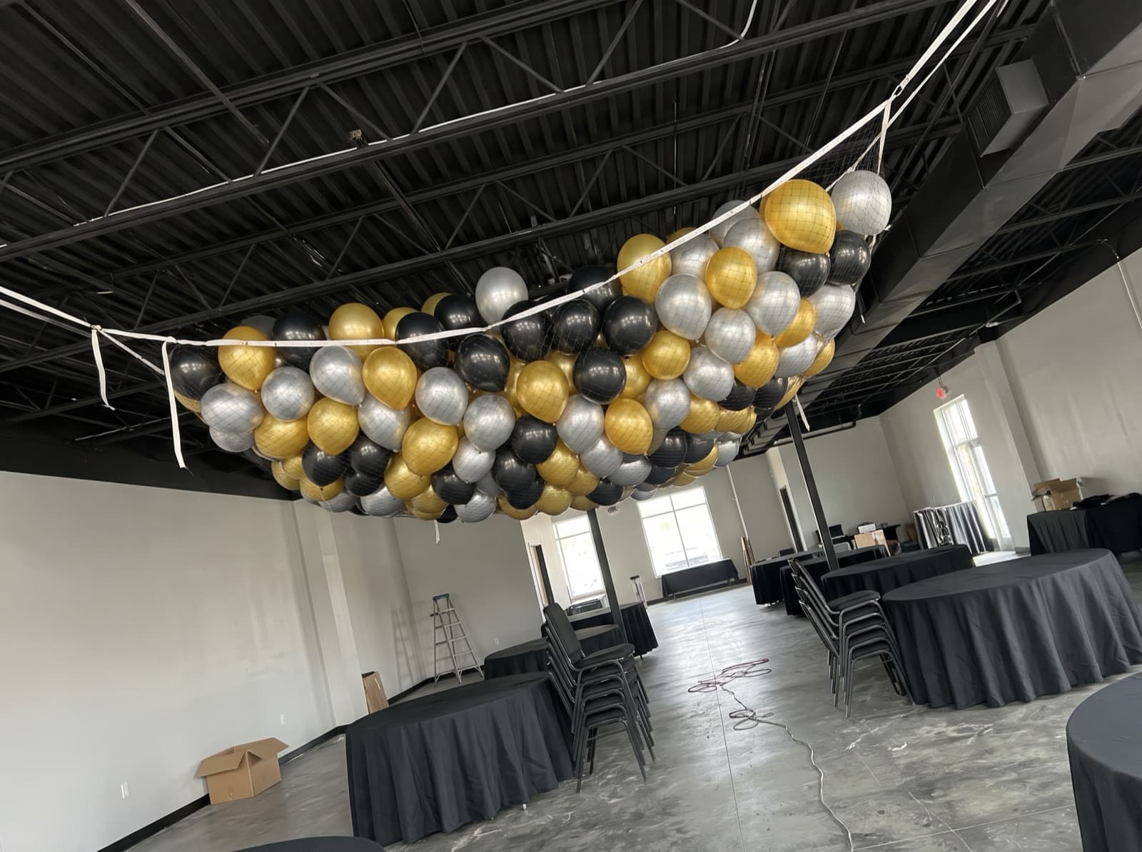 Balloon drop net overhead before a countdown