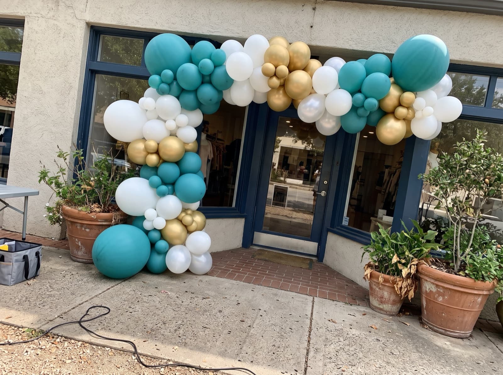 Giant balloon arch installation over a boutique entrance