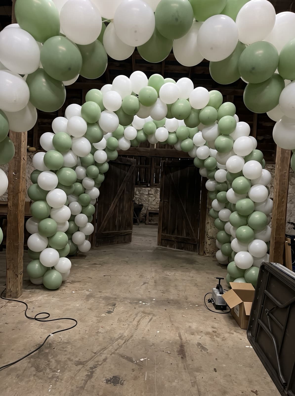 Balloon tunnel of linked arches in white and sage