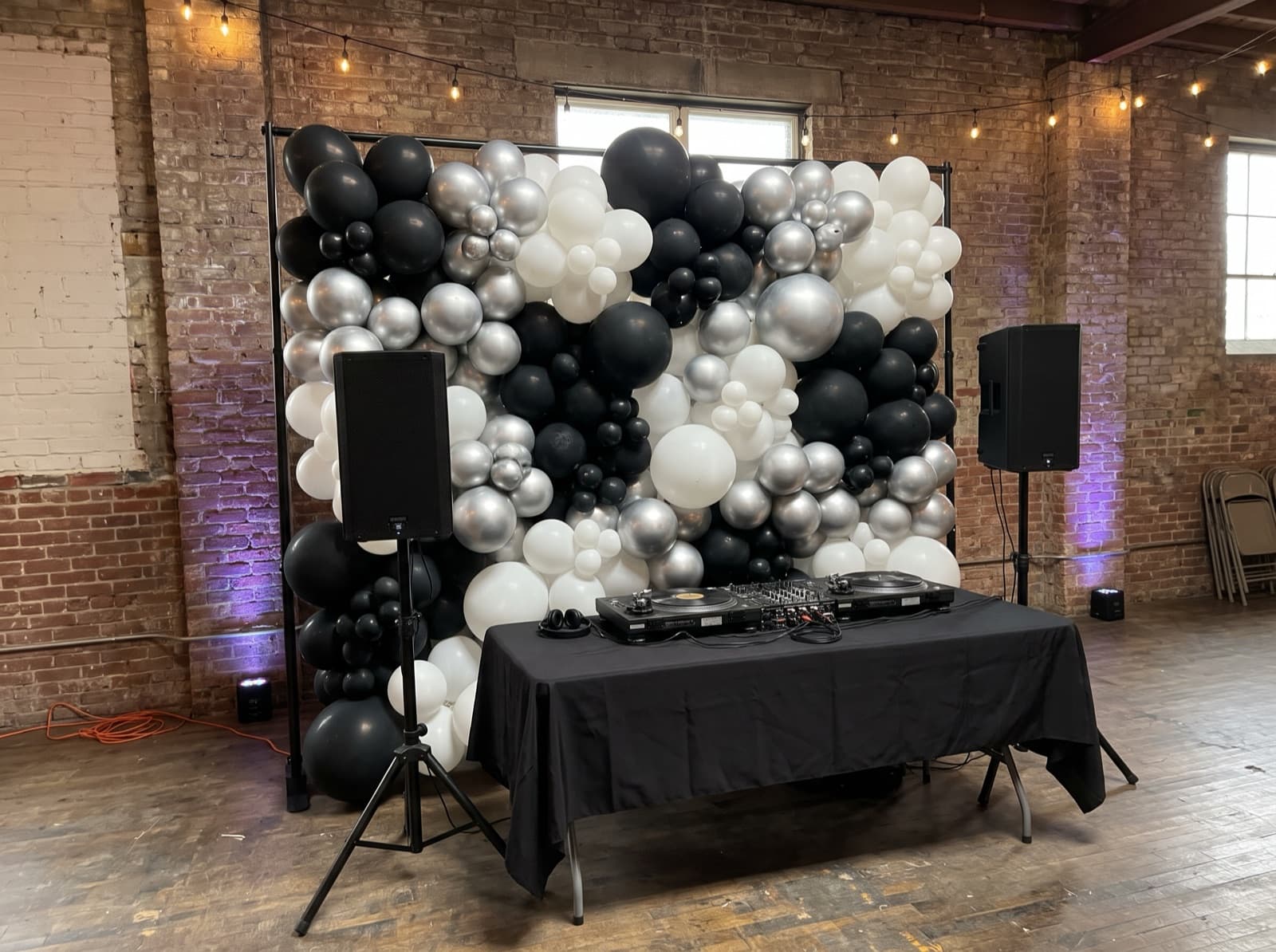 Solid balloon wall behind a DJ table