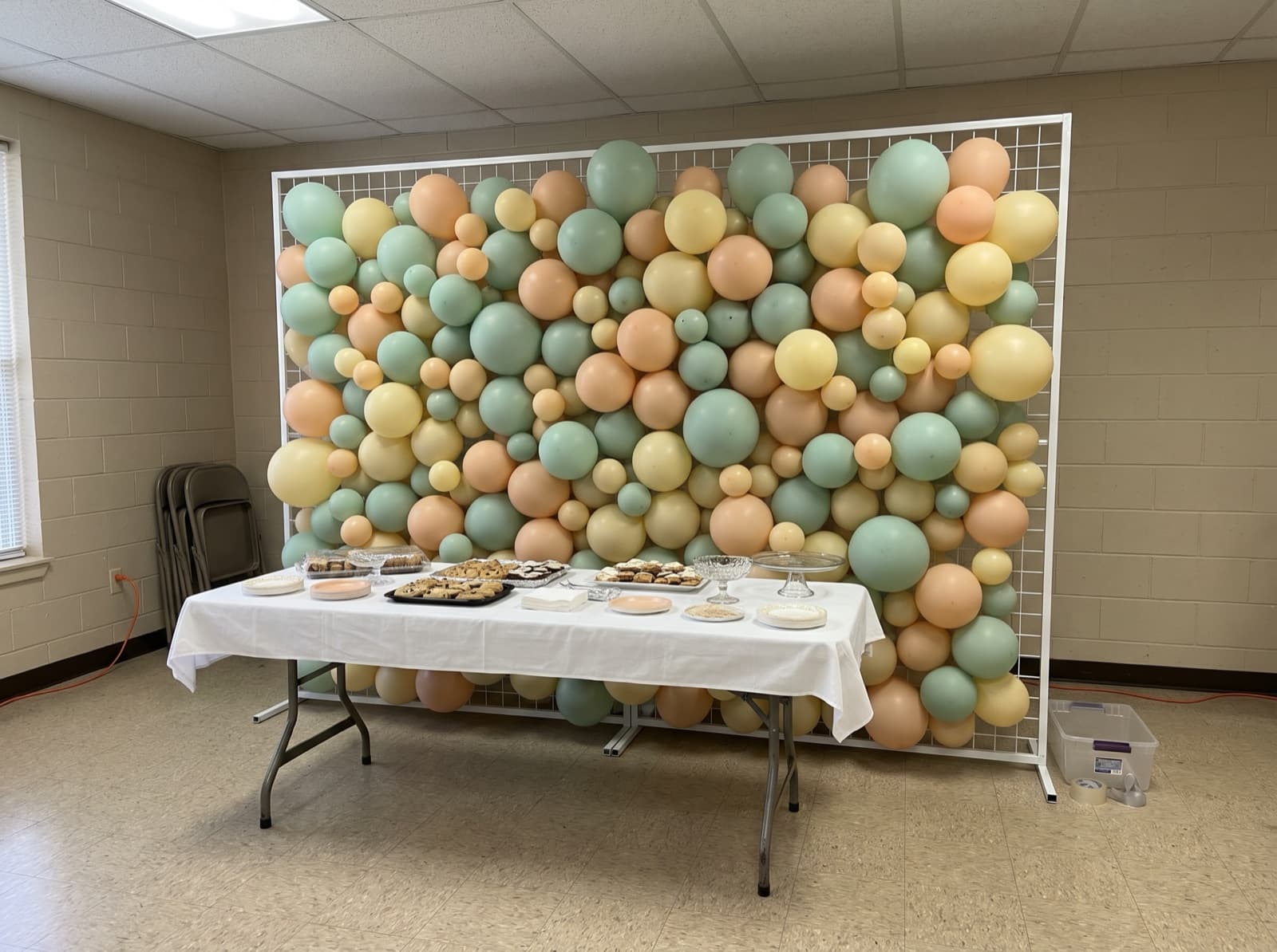 Rectangular framed balloon wall in mint, peach and yellow